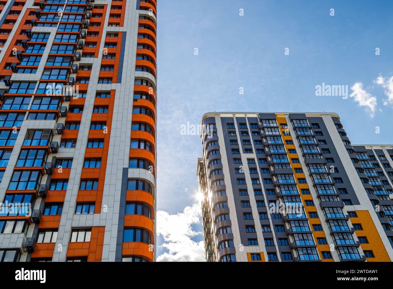 freshly built high rise apartment buildings on blue sky background with ...