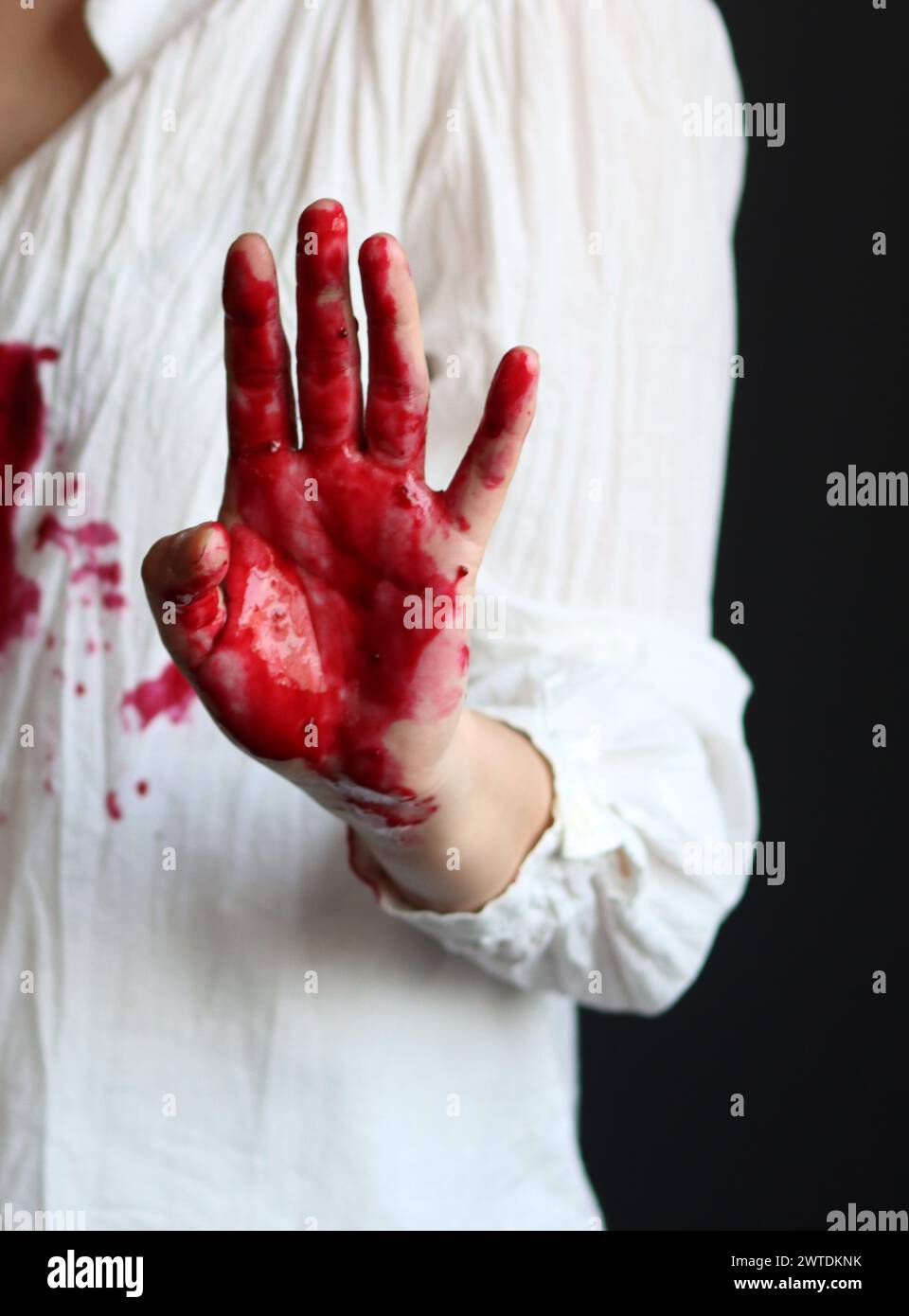 Female hands with blood on a black background with copy space. The concept of crime and domestic violence. Stock Photo