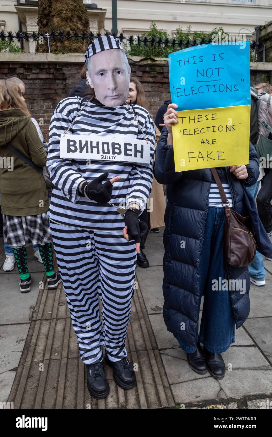 London, UK.  17 March 2024.  A person dressed as a handcuffed Vladimir Putin in a prison suit passes people queuing to vote at the Embassy of Russia near Notting Hill on the final day of voting in the Russian elections.  Yulia Navalnaya, widow of Russian activist Alexei Navalny who died in prison in February, has called for people to attend protests against the regime of Vladimir Putin and overwhelm polling stations as Putin seeks to win an additional term of 6 years.  Many of Putin’s opponents have either been killed, imprisoned or are in exile.  Credit: Stephen Chung / Alamy Live News Stock Photo