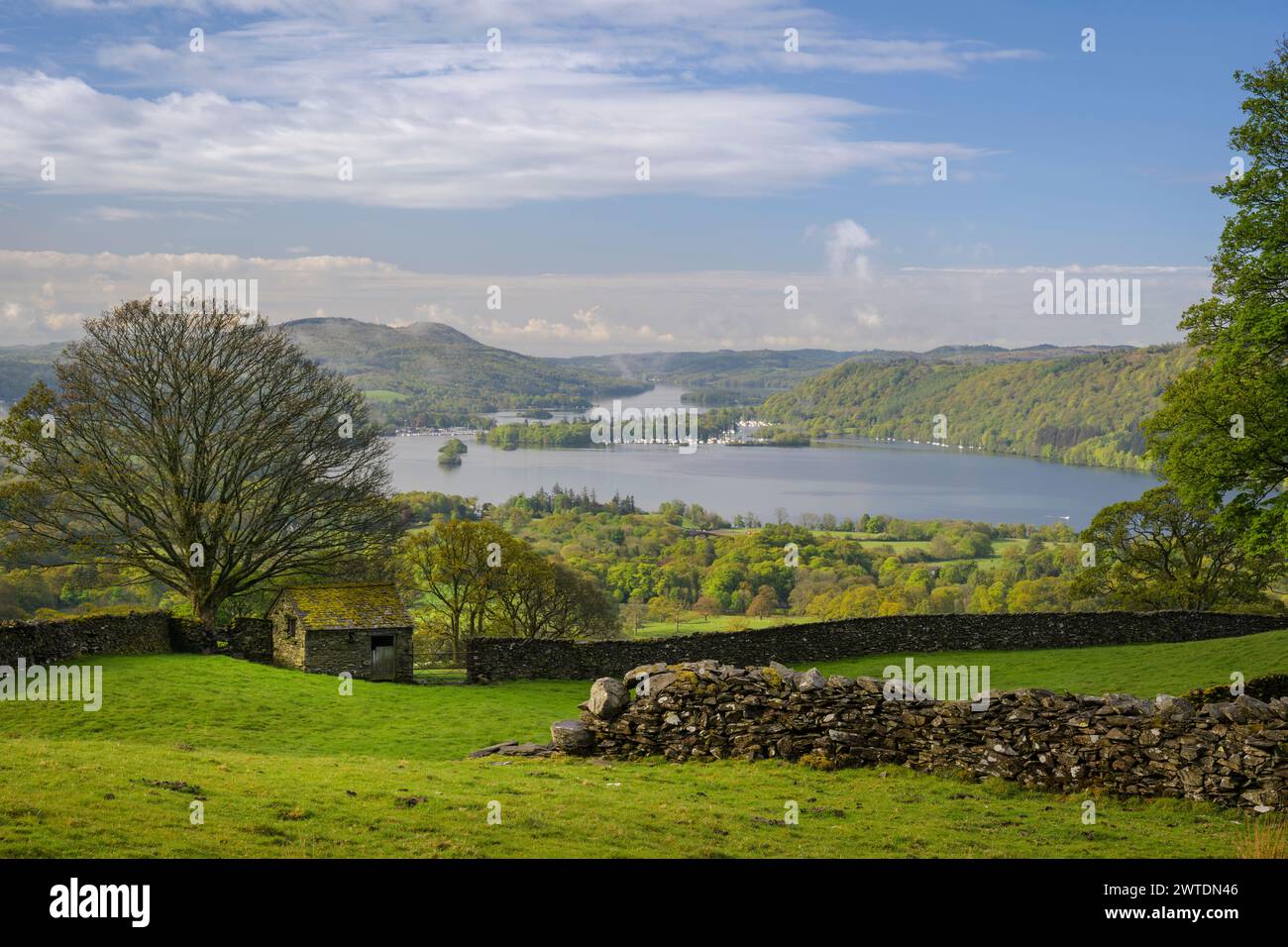 A stone barn in the spring morning sunshine overlooking lake Windermere. Stock Photo