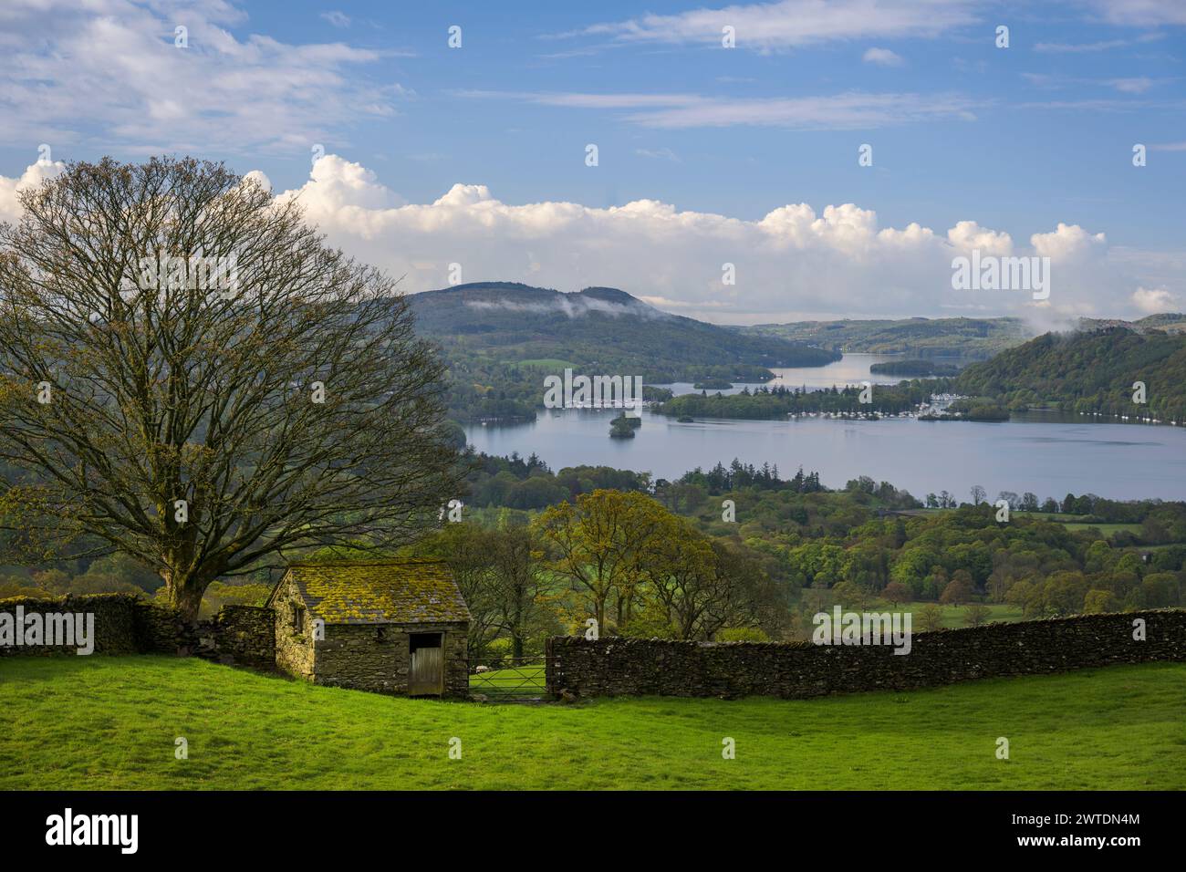 A stone barn in the spring morning sunshine overlooking lake Windermere. Stock Photo