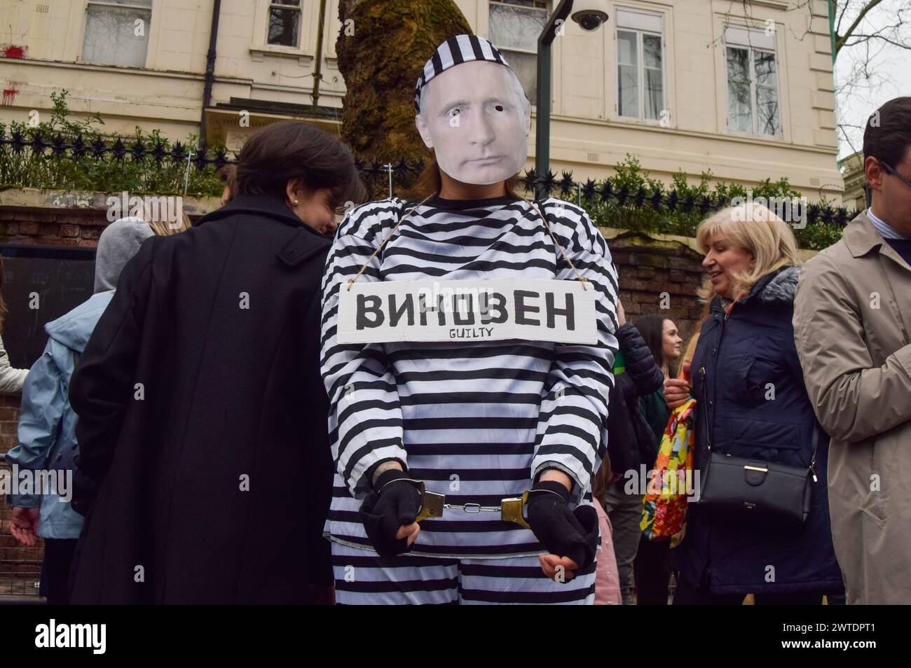 London, England, UK. 17th Mar, 2024. A protester dressed as Putin in prison clothing and wearing handcuffs stands outside the Russian Embassy in London while Russian citizens queue to cast their vote, as elections take place in Russia. (Credit Image: © Vuk Valcic/ZUMA Press Wire) EDITORIAL USAGE ONLY! Not for Commercial USAGE! Stock Photo