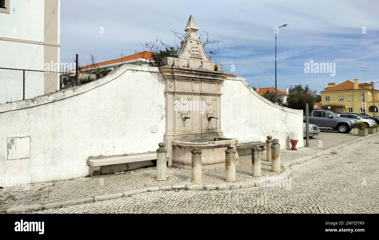 Ornate old stone water fountain decorated with stone carvings and mascarones, Alcacer do Sal, Portugal Stock Photo