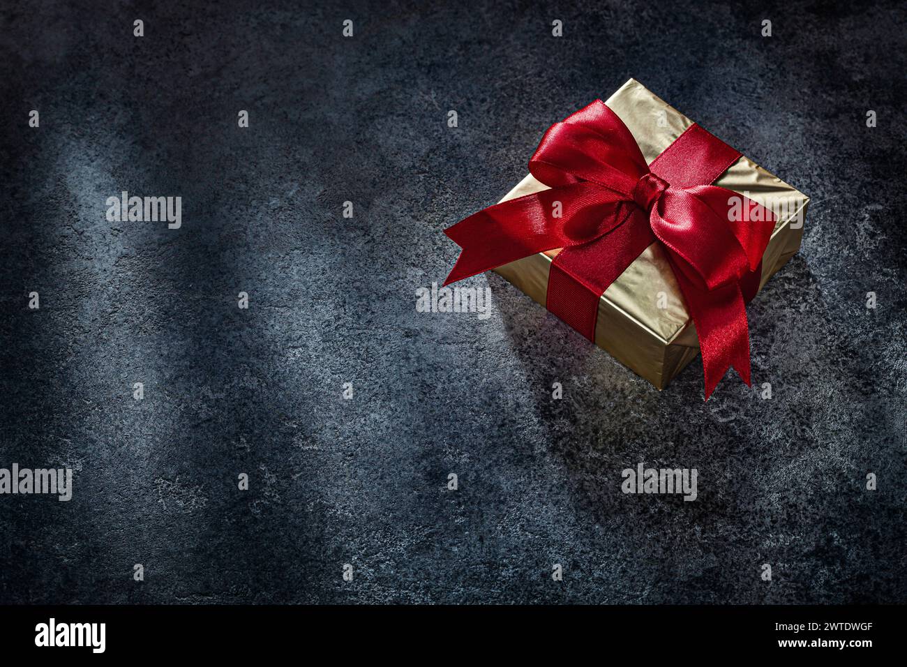Square Golden Gift Box On Dark Background Stock Photo