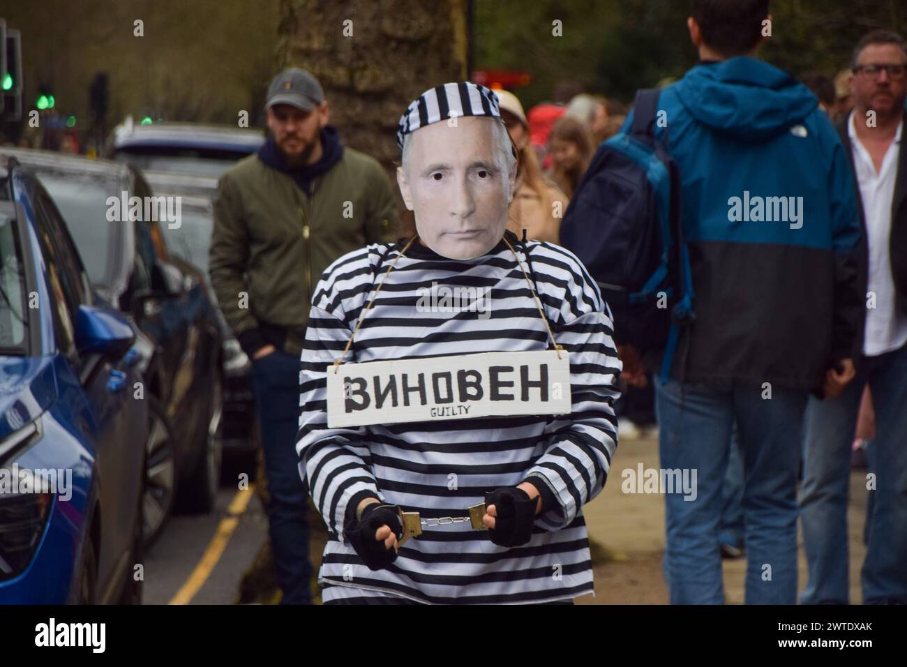 London, England, UK. 17th Mar, 2024. A protester dressed as Putin in prison clothing and wearing handcuffs stands outside the Russian Embassy in London while Russian citizens queue to cast their vote, as elections take place in Russia. (Credit Image: © Vuk Valcic/ZUMA Press Wire) EDITORIAL USAGE ONLY! Not for Commercial USAGE! Stock Photo