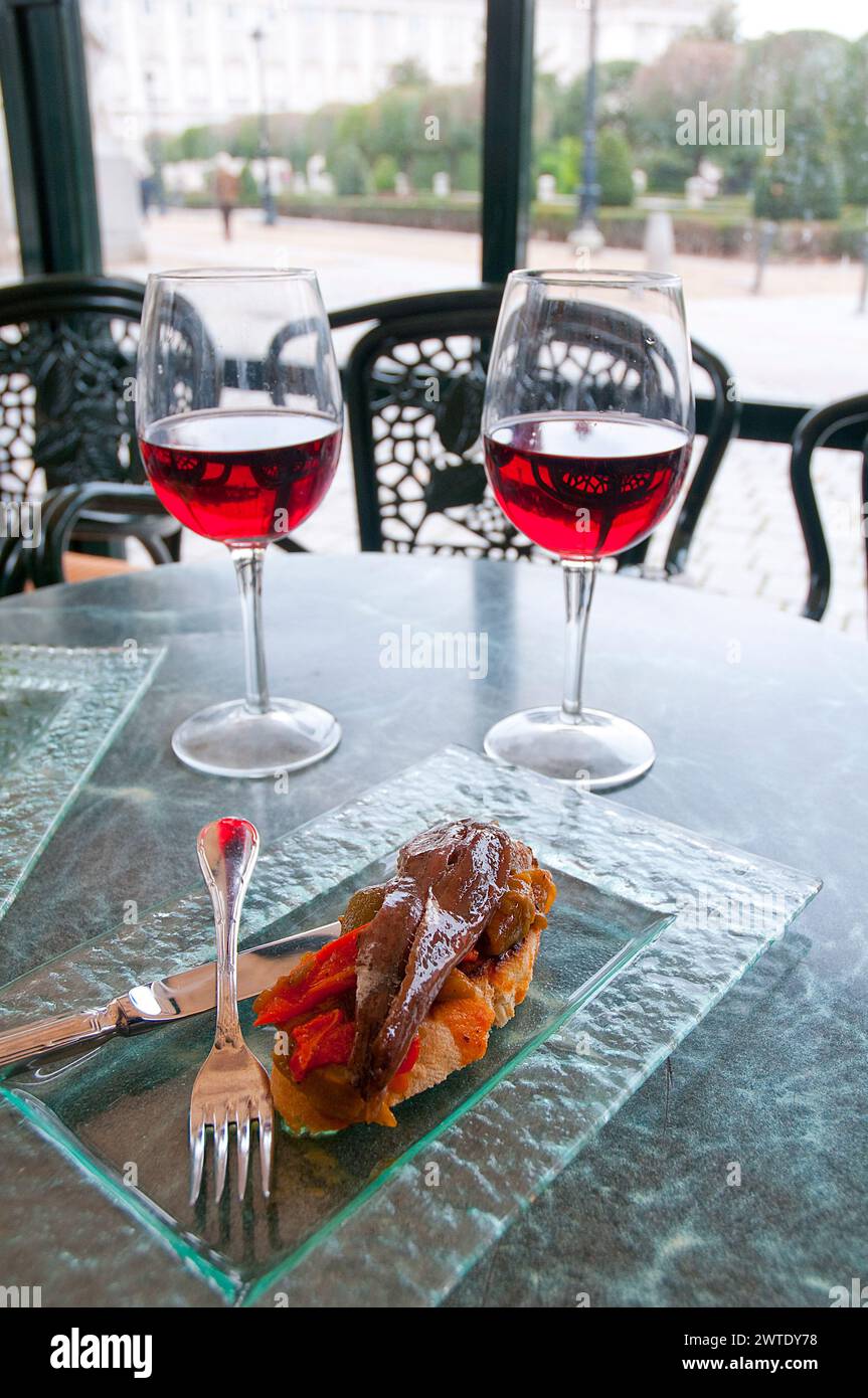 Two glasses of rose wine with tapa of anchovy fillet with red pepper. Madrid, Spain. Stock Photo
