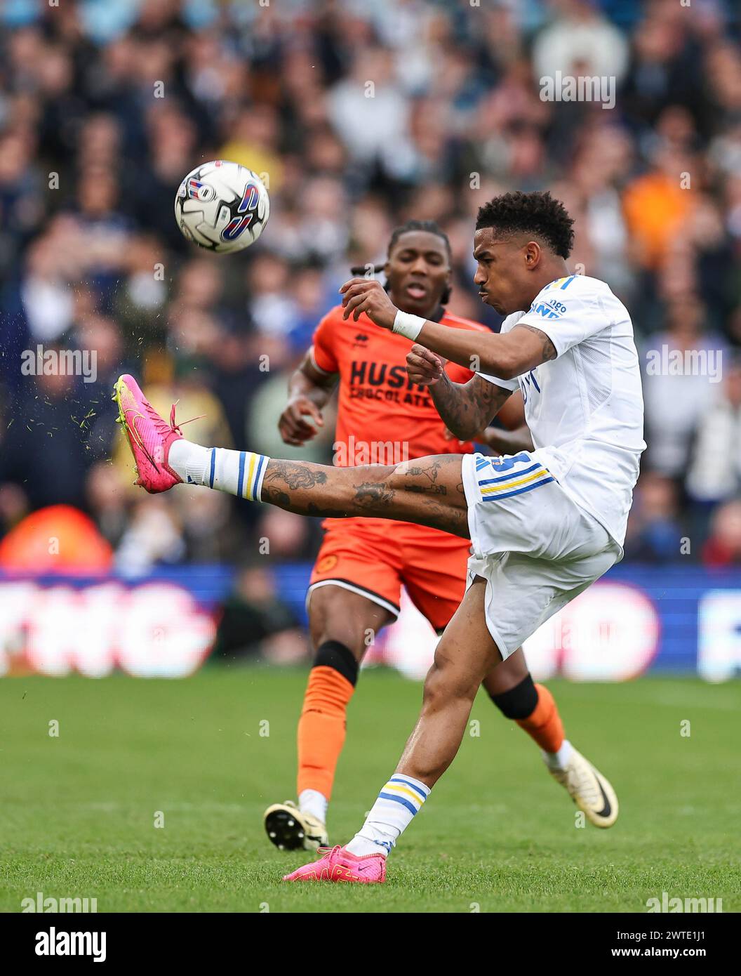 Elland Road, Leeds, Yorkshire, UK. 17th Mar, 2024. EFL Championship Football, Leeds United versus Millwall; Leeds United's Junior Firpo passes the ball with Millwall's Michael Obafemi pressuring Credit: Action Plus Sports/Alamy Live News Stock Photo