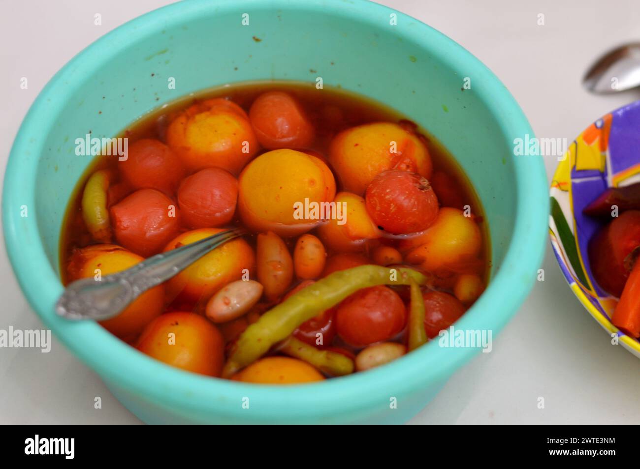 bowl of marinated vegetables (Torshi) or mixed pickled vegetables of lemon, onions, red peppers and salt, Egyptian appetizer Arabian cuisine, selectiv Stock Photo