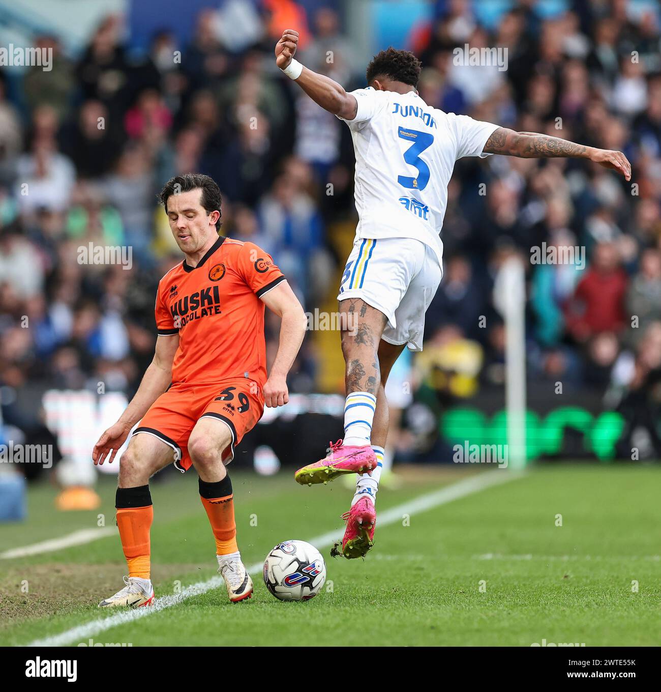Elland Road, Leeds, Yorkshire, UK. 17th Mar, 2024. EFL Championship Football, Leeds United versus Millwall; Leeds United's Junior Firpo is tackled by Millwall's George Honeyman Credit: Action Plus Sports/Alamy Live News Stock Photo