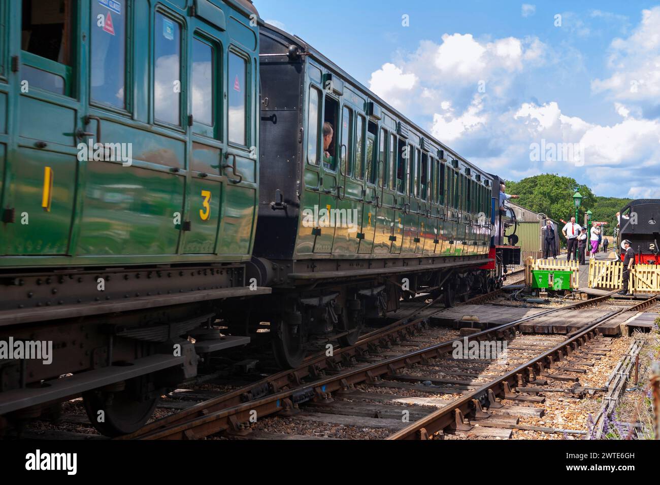 Exchanging tokens in order to progress onto the next section of single track: steam train approaching a station on the Isle of Wight Steam Railway Stock Photo