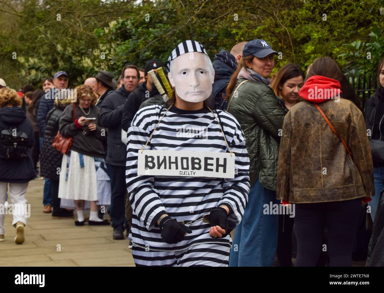 London, England, UK. 17th Mar, 2024. A protester dressed as Putin in prison clothing and wearing handcuffs walks outside the Russian Embassy in London while Russian citizens queue to cast their vote, as elections take place in Russia. (Credit Image: © Vuk Valcic/ZUMA Press Wire) EDITORIAL USAGE ONLY! Not for Commercial USAGE! Stock Photo
