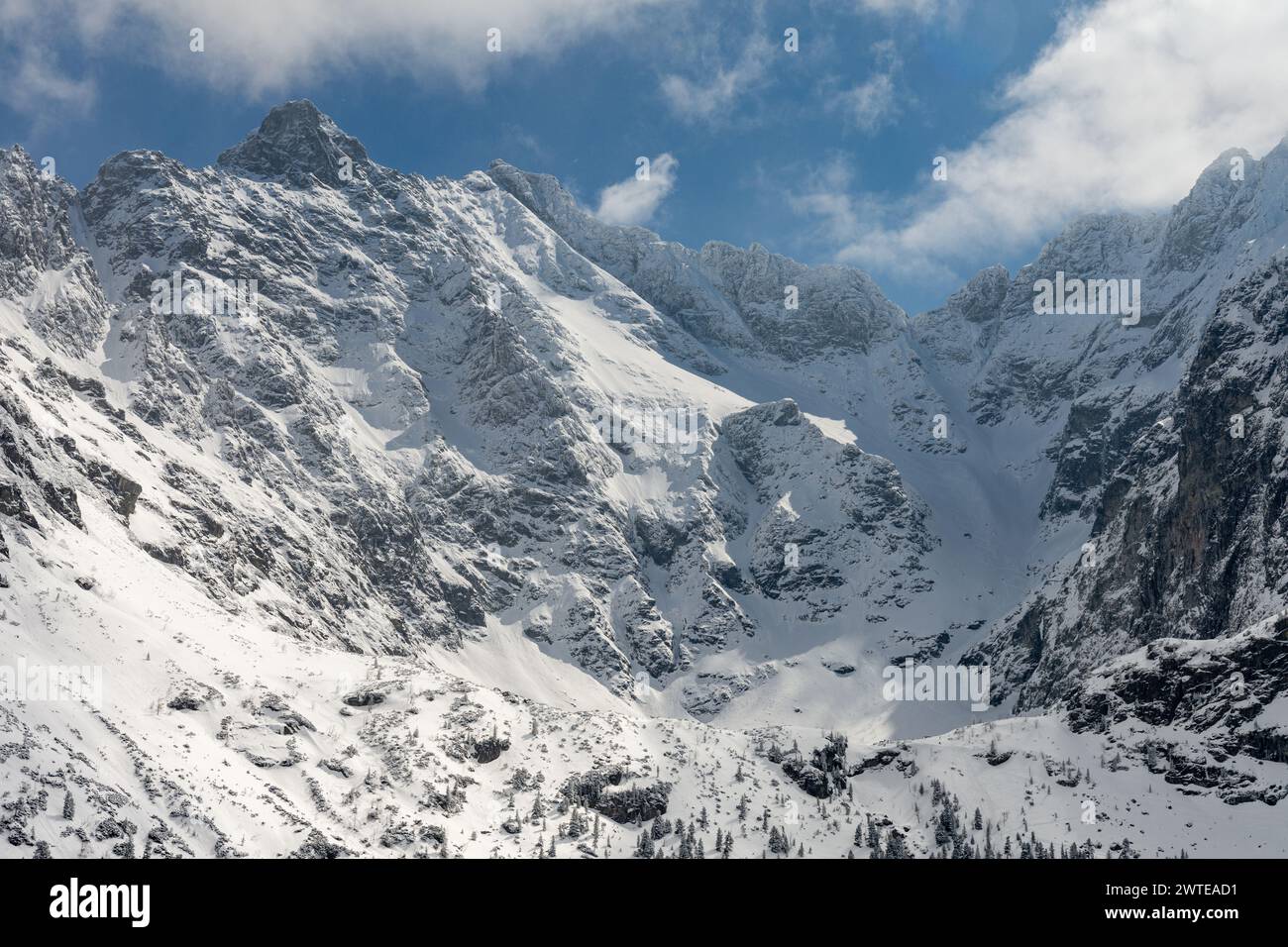Close look on Polish High Tatras mountains over Czarny Staw pod Rysami. In the bacground Rysy, Nizne Rysy, and Wolowa Turnia peaks covered with snow Stock Photo
