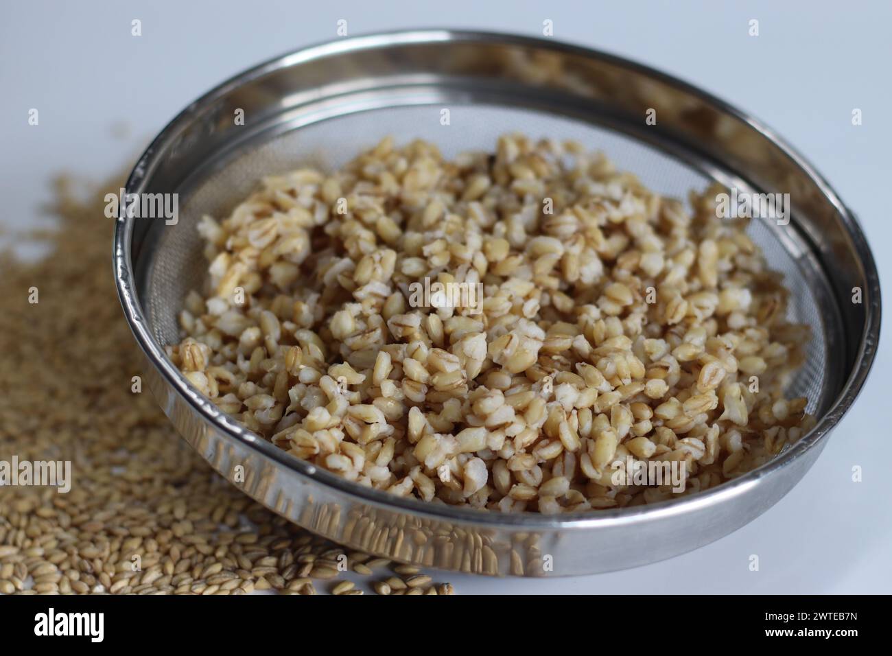 Soaked whole grain hulled barley in the strainer. Whole grain