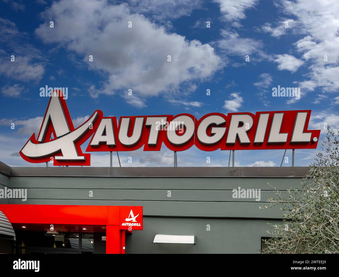 Brugnato, La Spezia, Italy - March 08, 2024: Autogrill sign on entrance of restaurant on A12 highway on cloudy blue sky . Autogrill is an Italian mult Stock Photo