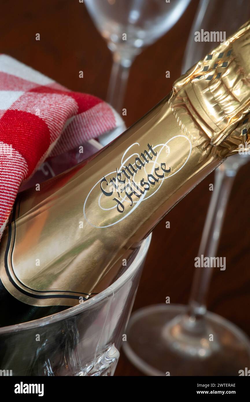 Cremant d’Alsace sparkling wine bottle in ice bucket with glasses