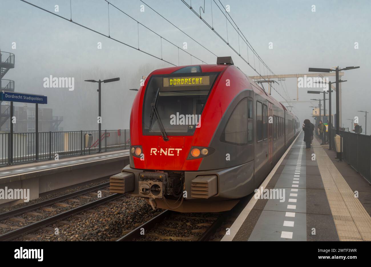 Passenger trains in morning misty railway stop in Dordrecht