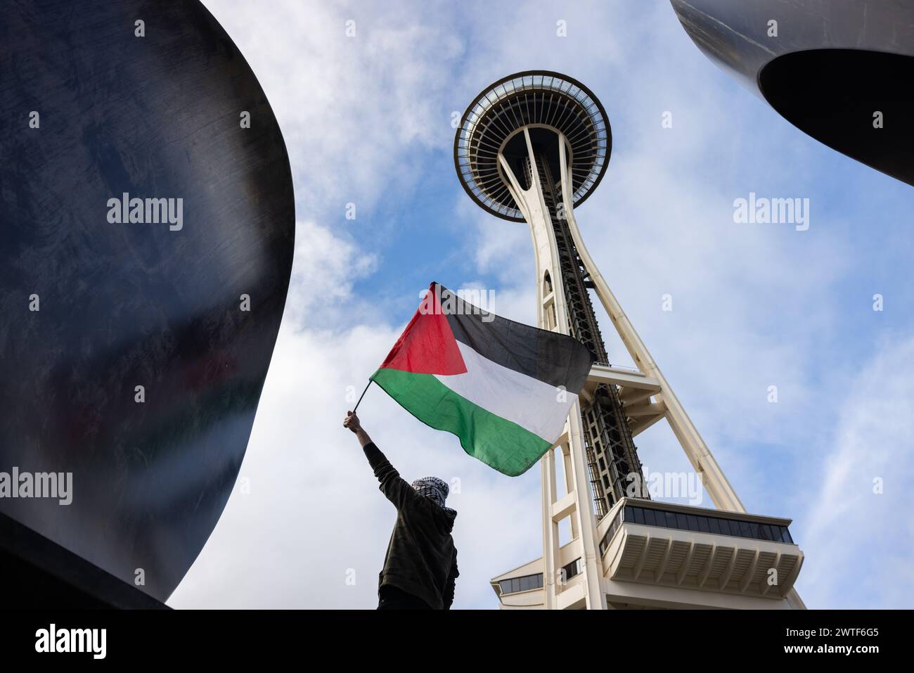 A Pro Palestine Demonstrator Waves A Palestine Flag Under The Space Needle In Seattle Stock Photo