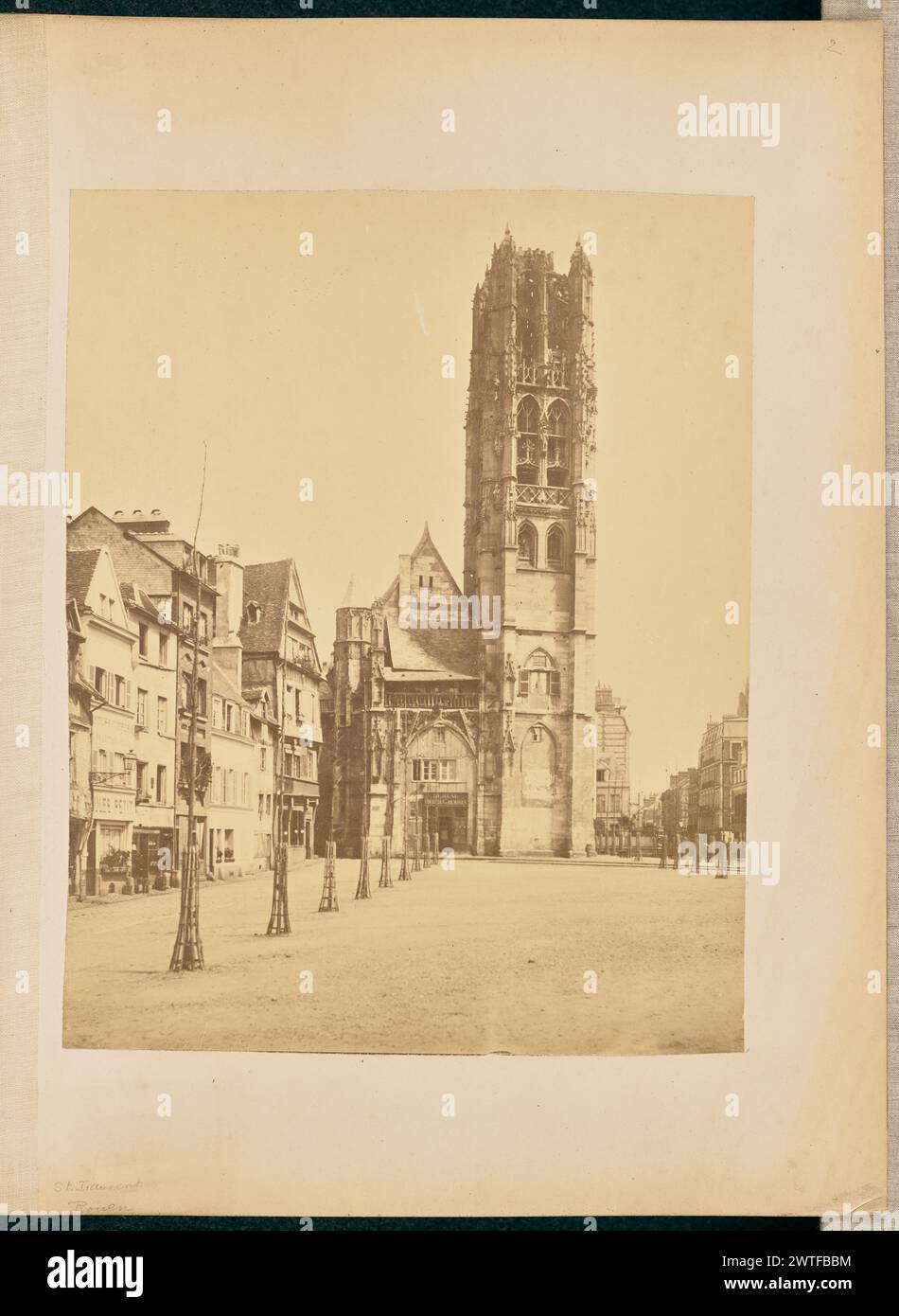 St. Laurent, Rouen. William J. Stillman, photographer (American, 1828 - 1901) about 1861 View of the Église Saint-Laurent in Rouen, currently the Musée le Secq des Tournelles, from across a square in front. The square is lines with shops and houses on one side, and two perfectly straight rows of saplings supported by cages aroung their trunks cut through the square. (Recto, mount) upper right, handwritten in pencil: '2'; Lower left, handwritten in pencil: 'St. Laurent / Rouen' Stock Photo