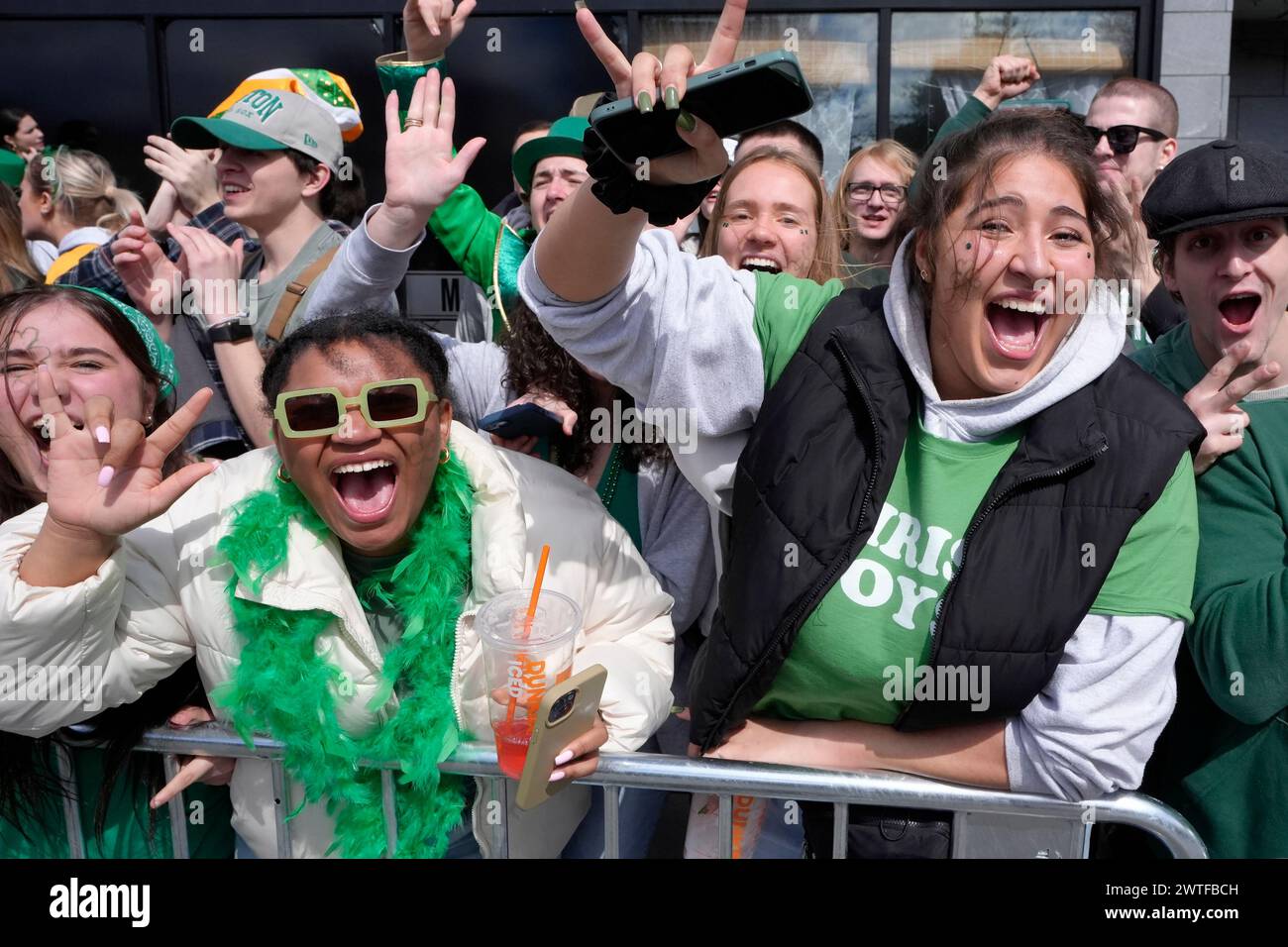 Spectators cheer while watching the St. Patrick's Day parade, Sunday ...