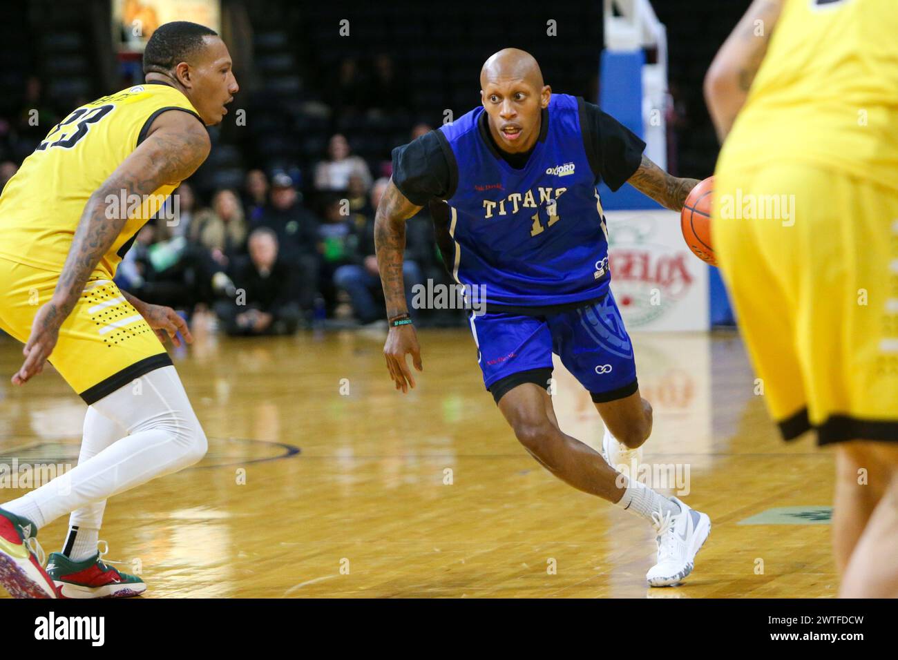 London, Canada. 17th Mar, 2024. London Ontario Canada. March 17 2024, The London Lightning defeat the Kitchener Titans 118-114 in regulation on St. Patrick's Day. Marque Maultsby (11) of Kitchener Titans tries to go around Billy White (23) of London Lightning. Credit: Luke Durda/Alamy Live News Stock Photo