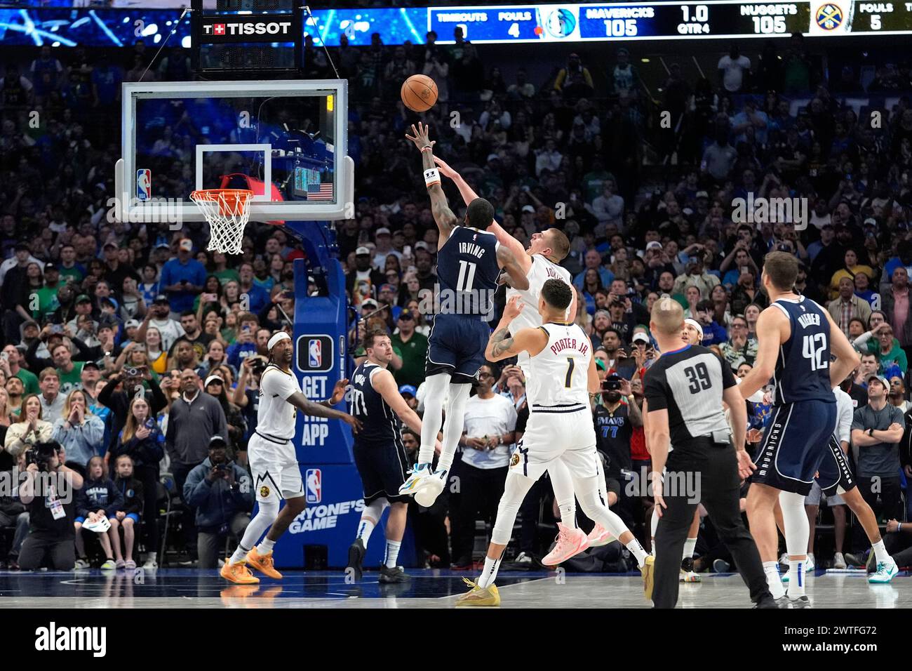 Dallas Mavericks guard Kyrie Irving (11) shoots the winning final-second basket against Denver Nuggets center Nikola Jokic, top center right, defends in an NBA basketball game in Dallas, Sunday, March 17, 2024. (AP Photo/LM Otero) Stock Photo
