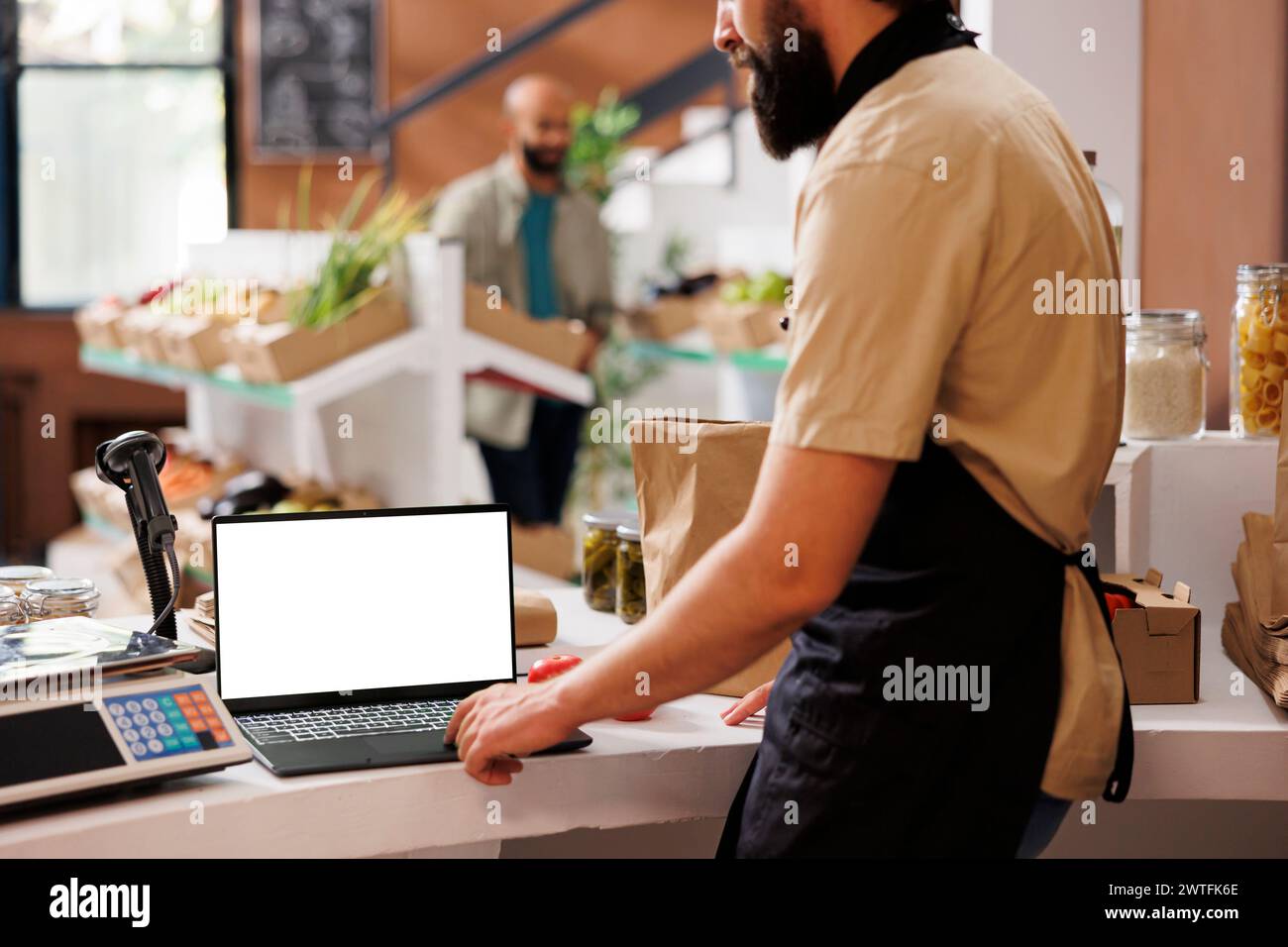 In zero waste convenience store, storekeeper waits to serve customers ...