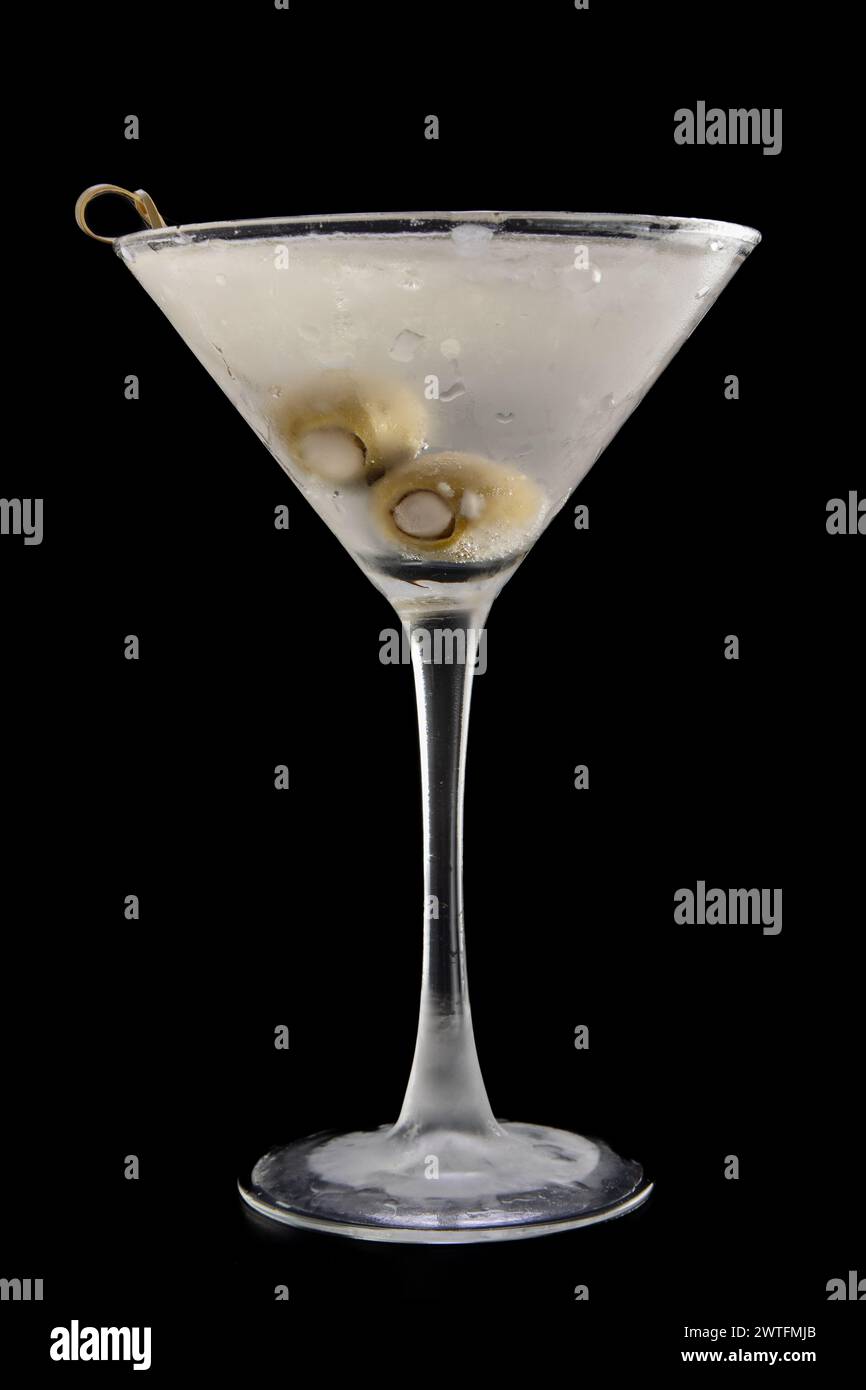 Chilled vodka martini with bleu cheese stuffed olives isolated over a