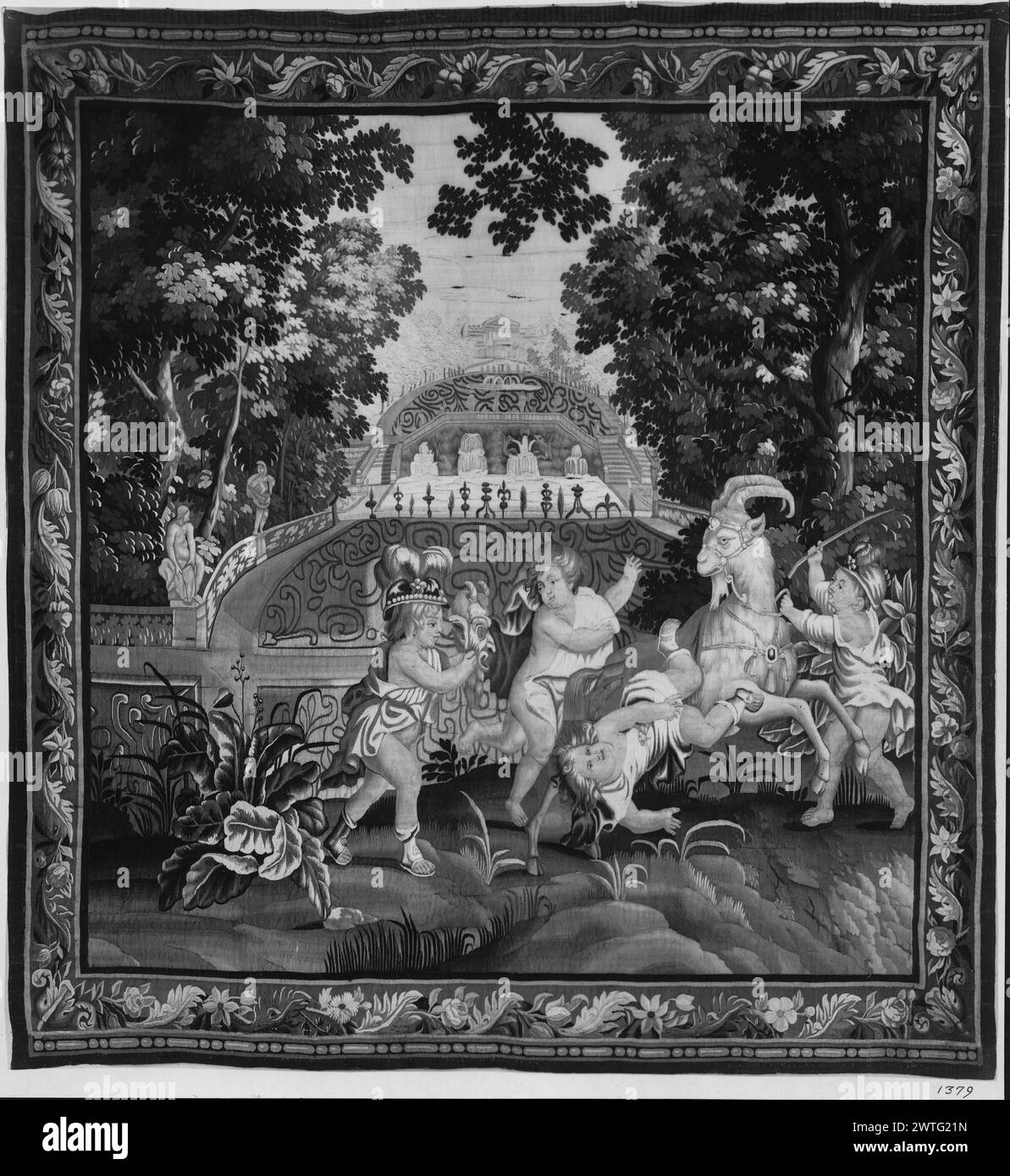 Bacchanalian children. unknown c. 1690 Tapestry Materials/Techniques: unknown Culture: English Weaving Center: unknown Ownership History: French & Co. 4 boys playing with goat, 1 tumbles off (foreground), one wears Indian-style headdress & holds mask, stylized garden with fountains & architectural scene (background) (BRD) garland of acanthus leaves & flowers with bead-&-reel molding Marillier discusses a set of 7 panels at Cotehele; this tapestry matches the description (see pl. 10b). He also identifies 2 other copies: one belonged to Mrs. Fetherston-Godly, the other to Colonel John Harvey of Stock Photo