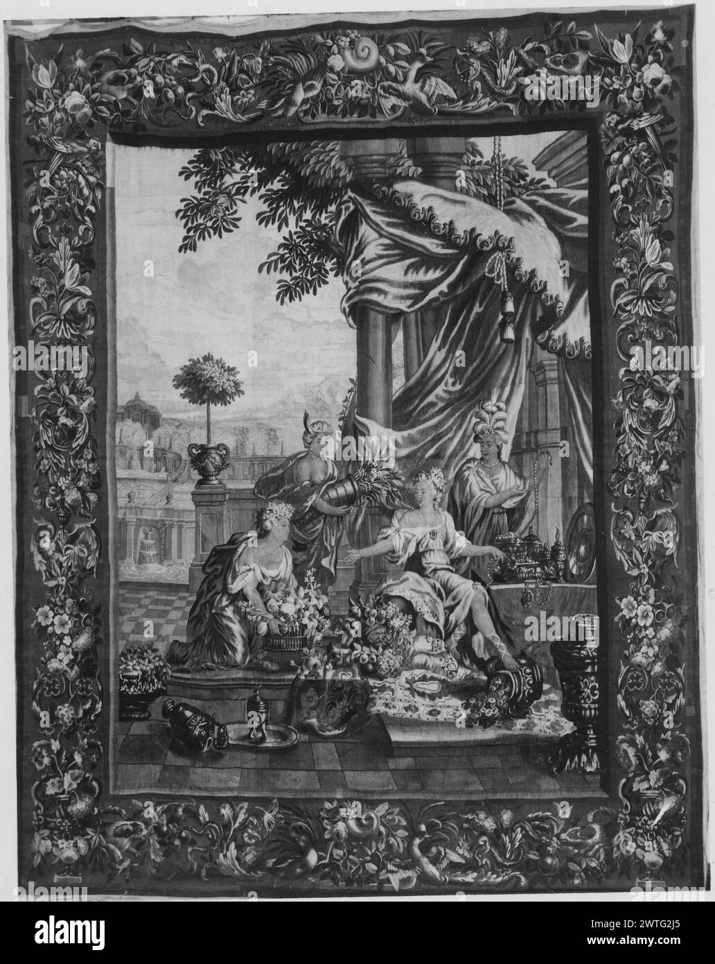 Abundance. Schoor, Lodewijk van (Flemish, 1666-1726) (author of design, figures) [painter] Spierincx, Pieter (Flemish, act.1614-1647) (author of design, landscape workshop) [painter weaver] c. 1699 Tapestry Dimensions: H 11'4' x W 8'8' Tapestry Materials/Techniques: unknown Culture: Flemish Weaving Center: unknown Ownership History: French & Co. On terrace, personification of Abundance seated with right foot resting on vessel filled with coins, surrounded by 3 attendants, 1 kneeling & holding basket of flowers, 1 carrying cornucopia, another with feather headdress standing by table with vessel Stock Photo