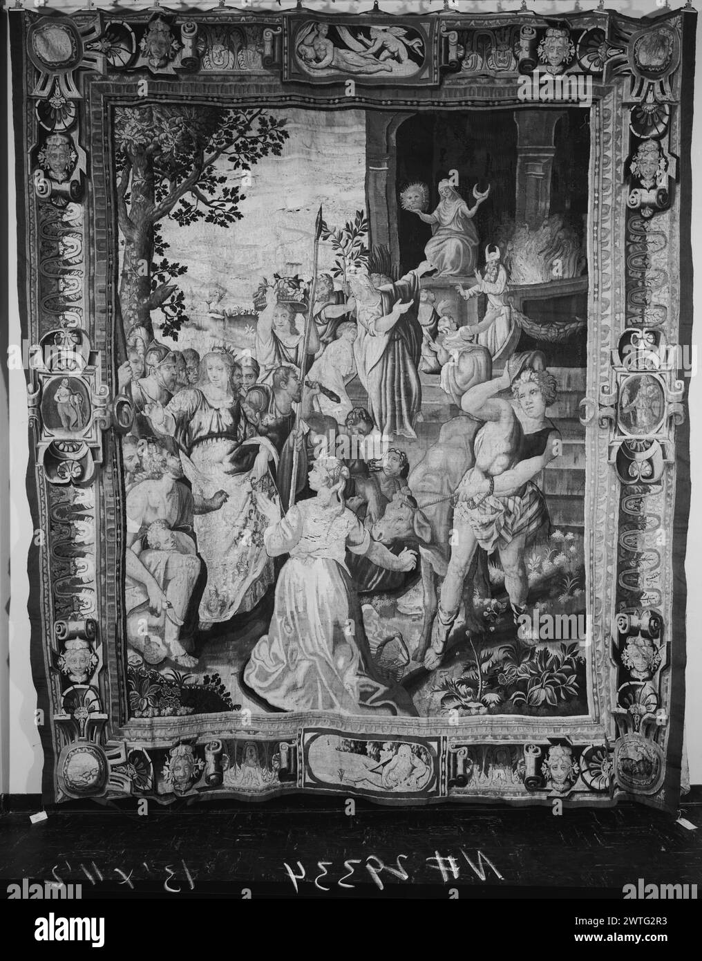 Niobe dissuades people from worshiping Latona. Dubreuil, Toussaint (French, 1561-1602) (author of design) [painter] c. 1630 Tapestry Dimensions: H 13' x W 11' 2' Tapestry Materials/Techniques: unknown Culture: French Weaving Center: Paris Ownership History: French & Co. (?). Given to the Cincinnati Art Museum by Mr. & Mrs. Harry S. Leyman. United States, Ohio, Cincinnati, Cincinnati Art Museum, accno. 1941.98. Niobe insults the goddess Latona & opposes her religious cult; Latona, seated in upper R, holds the sun of Apollo & the moon of Diana, priest to R attends a sacrificial fire (BRD) wave b Stock Photo