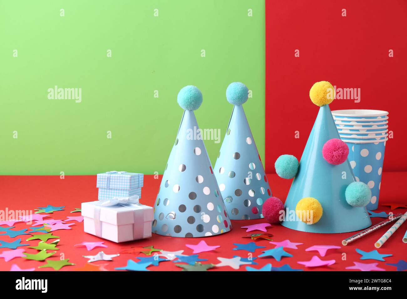 Party hats and other bright decor on color background Stock Photo - Alamy