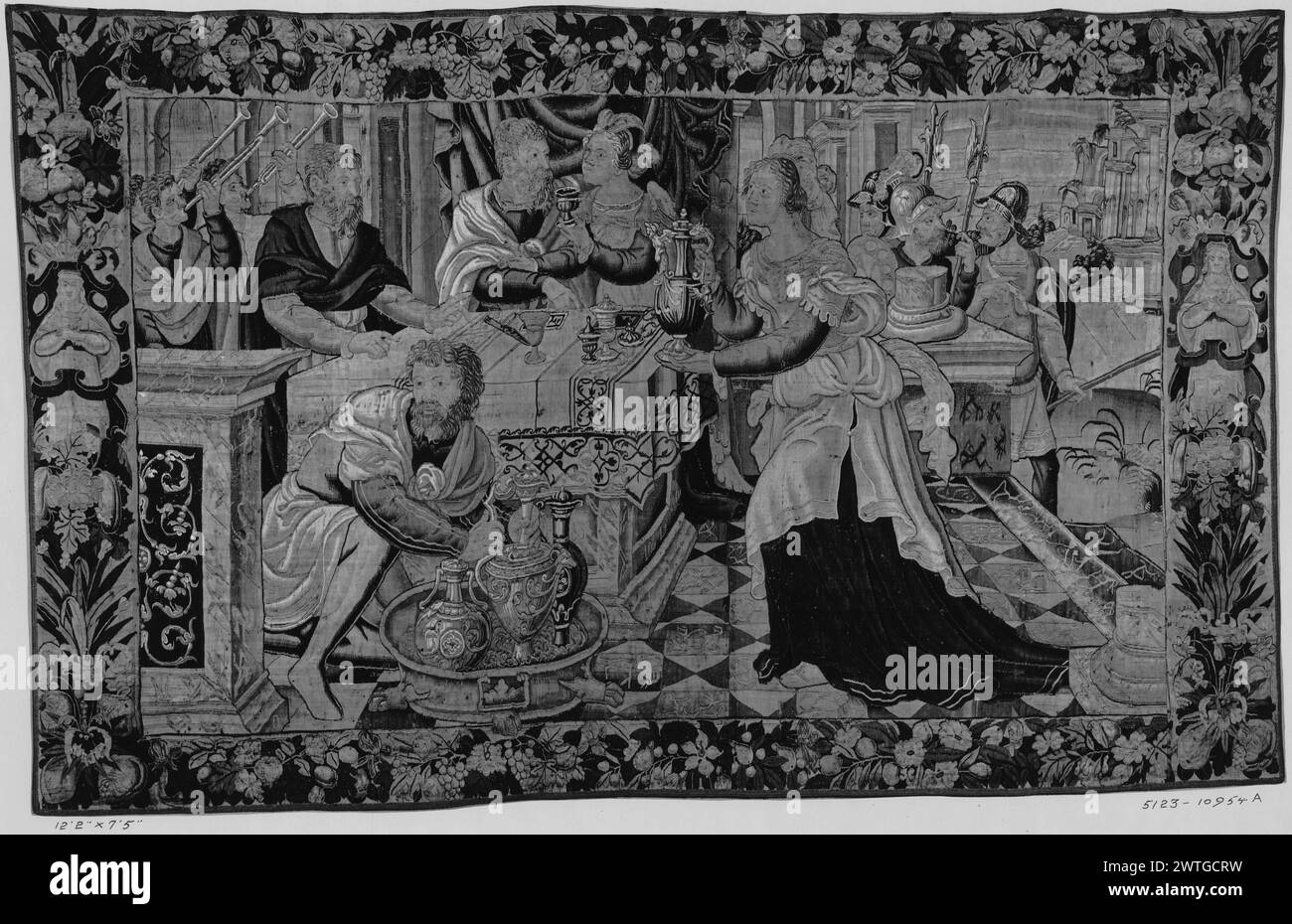 Banquet of Holofernes. unknown c. 1600 Tapestry Dimensions: H 7'5' x W 12'2' Tapestry Materials/Techniques: unknown Culture: Flemish Weaving Center: Oudenaarde Ownership History: French & Co. purchased from Courtard, Israel & Wessels, [n.d.] (per our letter 12/8/1922); sold to J. M. Studebaker Jr. 12/1/1922. Within outdoor architectural setting, Holofernes & Judith seated together at table, surrounded by attendants (Judith 8-16); trumpeters & soldiers in middle ground (BRD) twisting garland of oversize flowers & fruit; (L & R BRD) brackets with female herm-like figures French & Co. stock sheet Stock Photo