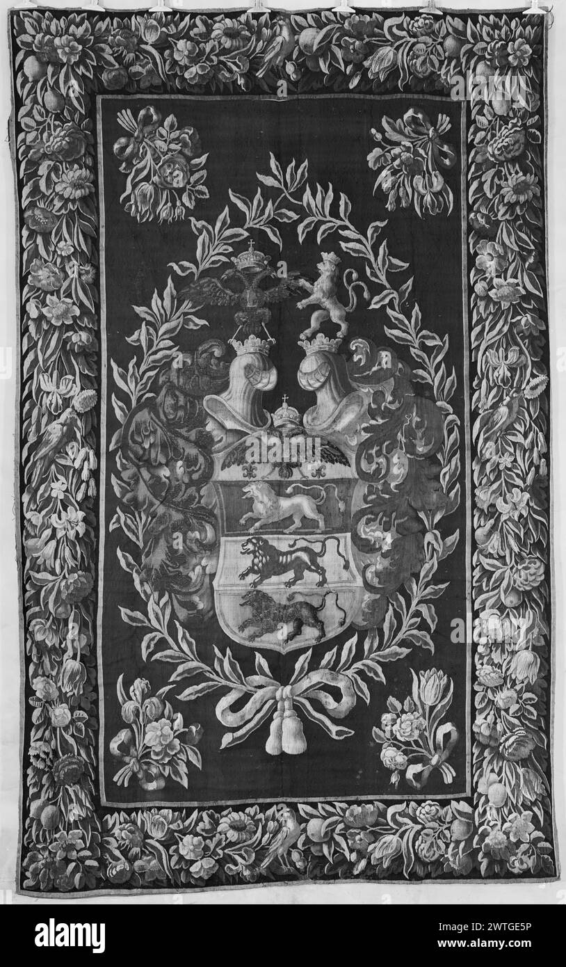 Table cover with coat of arms of knight. unknown c. 1650-1700 Tapestry Dimensions: H 10' x W 6' Tapestry Materials/Techniques: unknown Culture: Flemish Weaving Center: unknown Ownership History: French & Co. purchased from Mr. Enzio Rehbinder, received 10/19/1951; sold to Jean Michaeloff 1/16/1962. Coat of arms of knight with paternal connection to the Holy Roman Emperor: 4 stacked compartments with lions in 3 & eagle in top, surmounted by crown; arms in wreath with tied bouquets in corners (BRD) garland with fruit & flowers French & Co. stock sheet in archive, 51510 Stock Photo