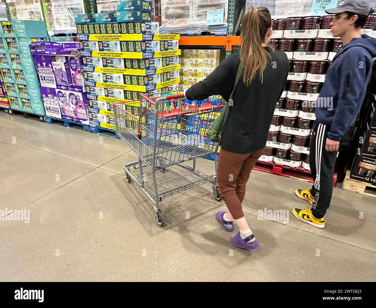 Shoppers pass by displays of goods in a Costco warehouse Sunday, March ...