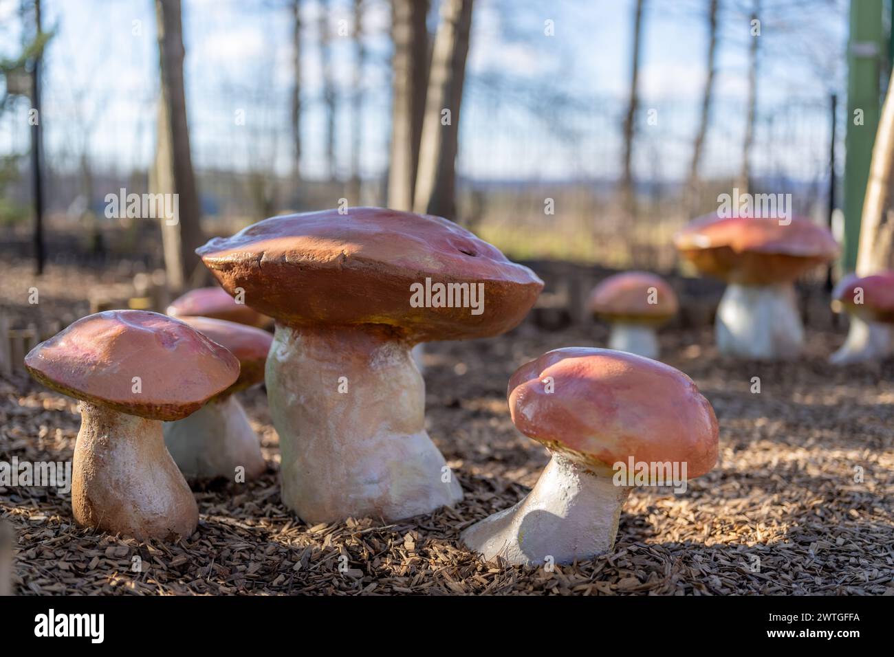 Side view of a custom children's playground seats, bench, in the shape of a toadstool or mushroom. Stock Photo
