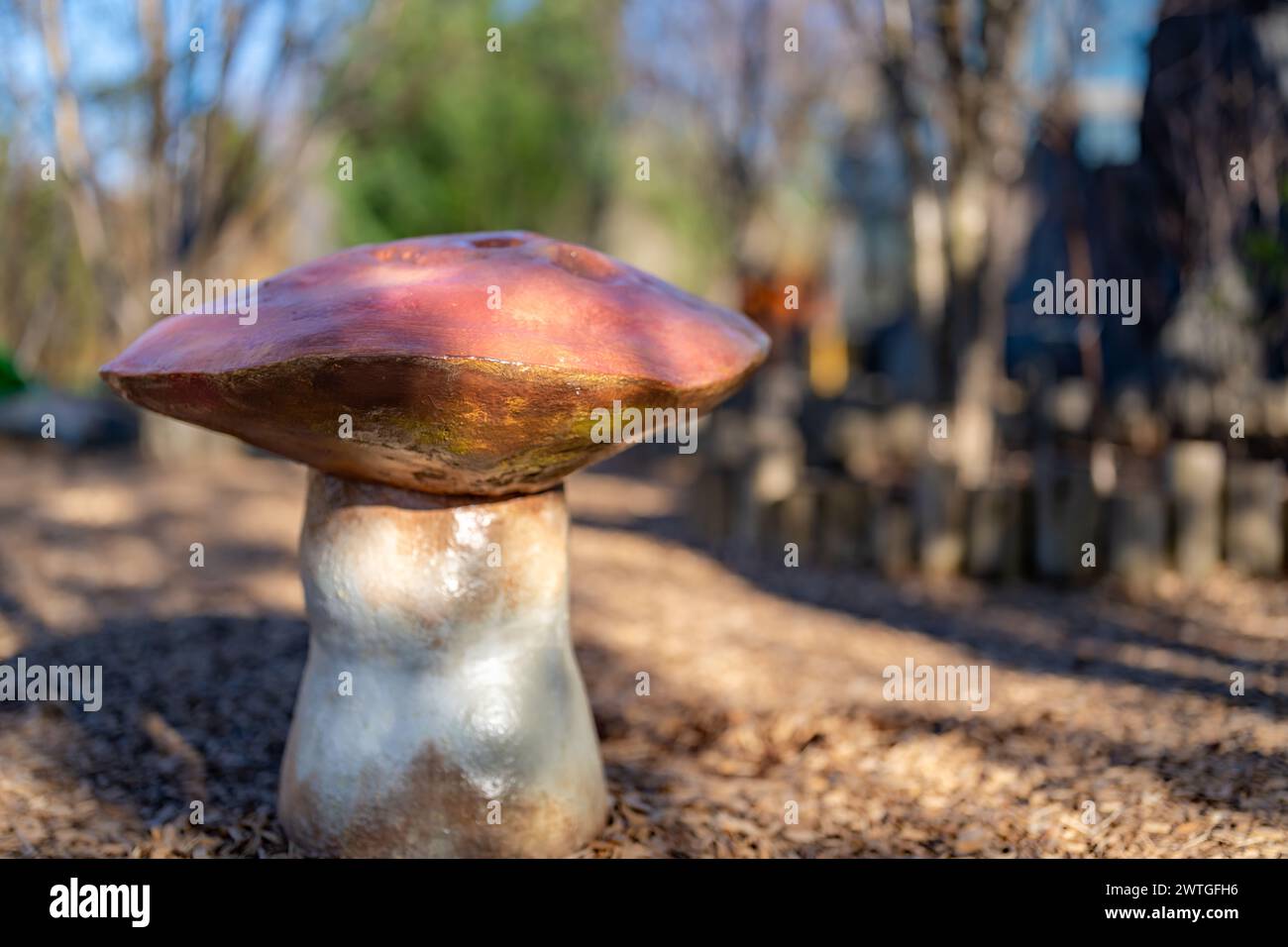 Side view of a custom children's playground seats, bench, in the shape of a toadstool or mushroom. Stock Photo