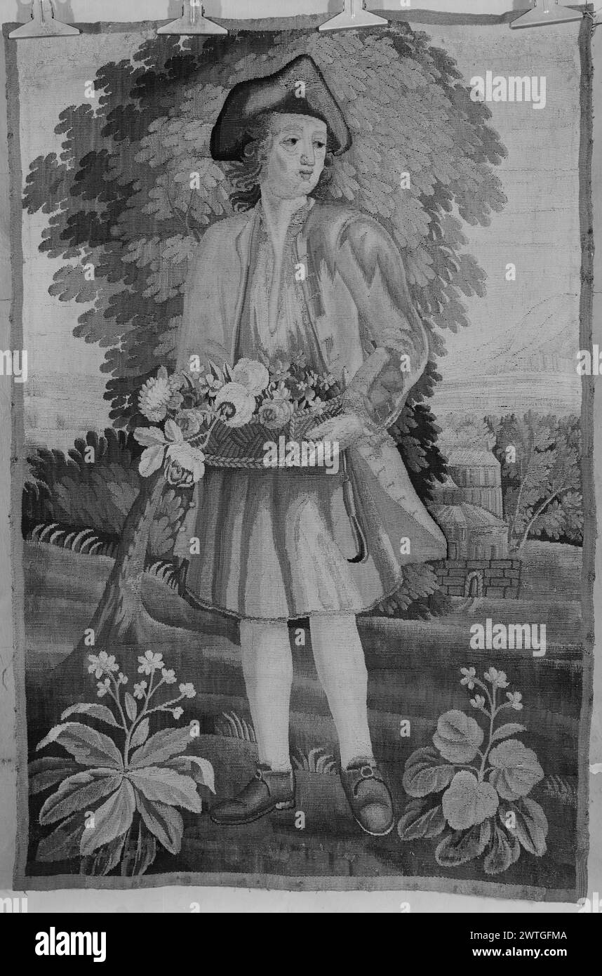 Gardener in landscape carrying basket of flowers. unknown c. 1720-1750 Tapestry Dimensions: H 3'4' x W 2'3' Tapestry Materials/Techniques: unknown Culture: French Weaving Center: Aubusson Ownership History: French & Co. purchased from Gluck Selig, invoiced 3/25/1929; sold to Mrs. Roy Arthur Hunt 4/17/1962. In landscape with trees & flowering plants, a gardener holds with his 2 hands a basket filled with flowers, a garden tool hanging from his jacket; building in background Fragment with narrow border. French & Co. stock sheet in archive, 33885 Stock Photo