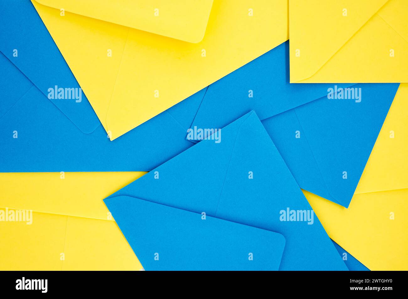 Blue and yellow paper envelopes organized in a symmetrical pattern ...