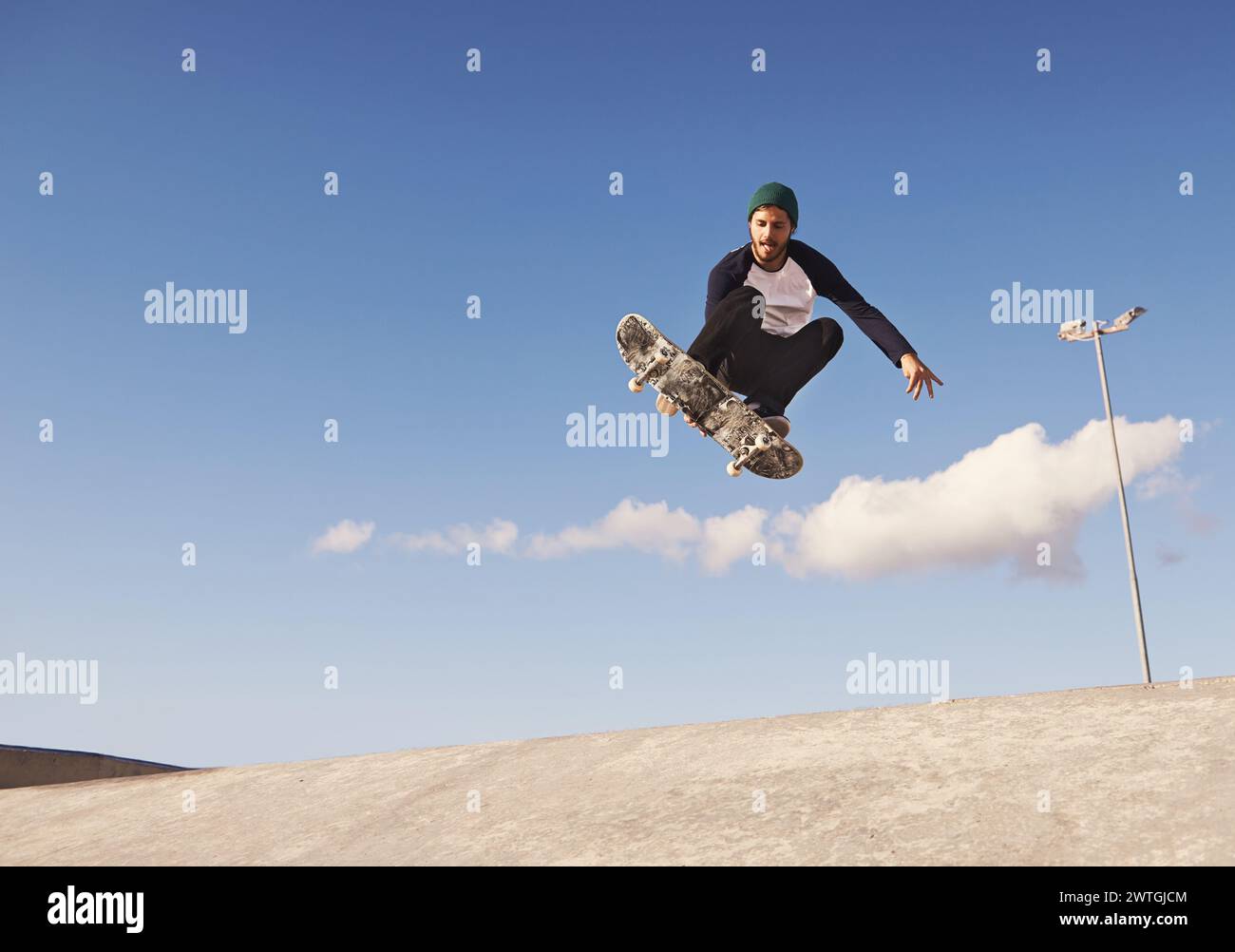 Skateboard, blue sky and man with ramp, challenge and training for a ...
