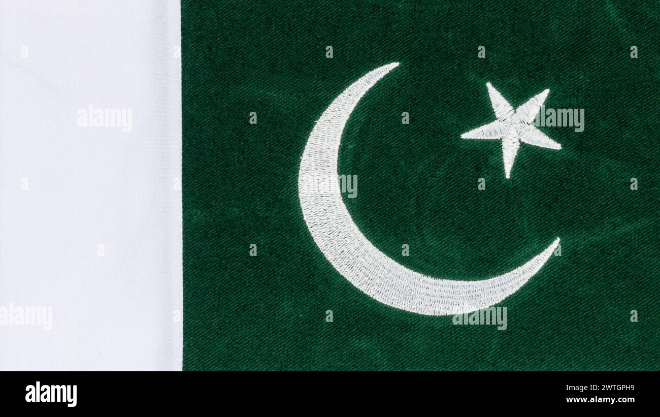 Pakistan flag consists of dark green with a white vertical stripe, a white crescent and a five pronged star in the middle Stock Photo