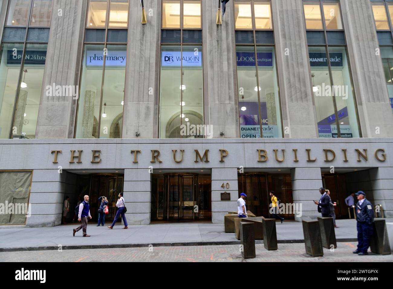 Entrance of The Trump Building with names on the facade and passers-by in front of it, Manhattan, New York City, New York, USA, North America Stock Photo