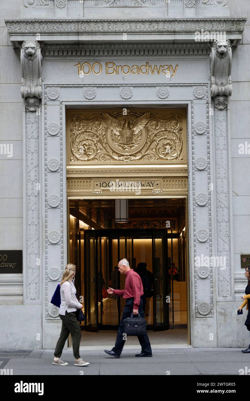 Two people walk past an ornate historic building entrance, Manhattan, New York City, New York, USA, North America Stock Photo