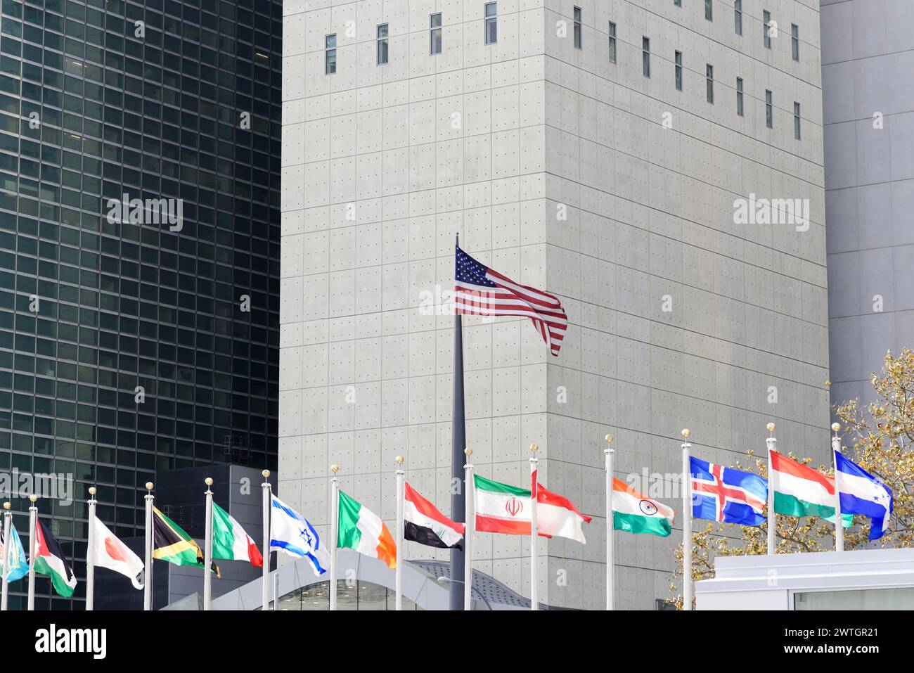 UN Headquarters, East River, Manhattan, row of international flags against the background of a modern building, New York City, New York, USA, North Stock Photo