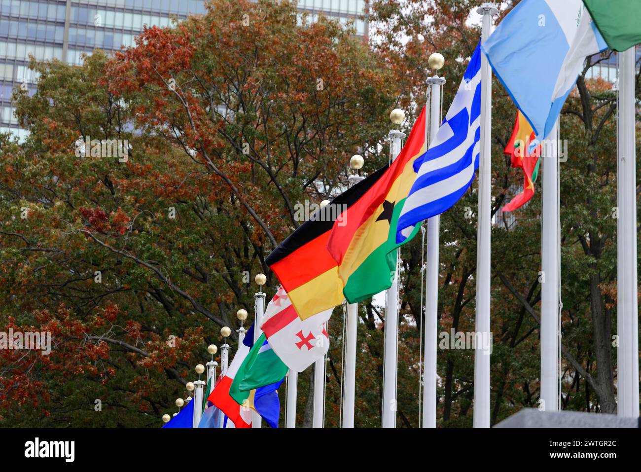 UN Headquarters, East River, Manhattan, Colourful flags of different countries waving in front of a building, New York City, New York, USA, North Stock Photo