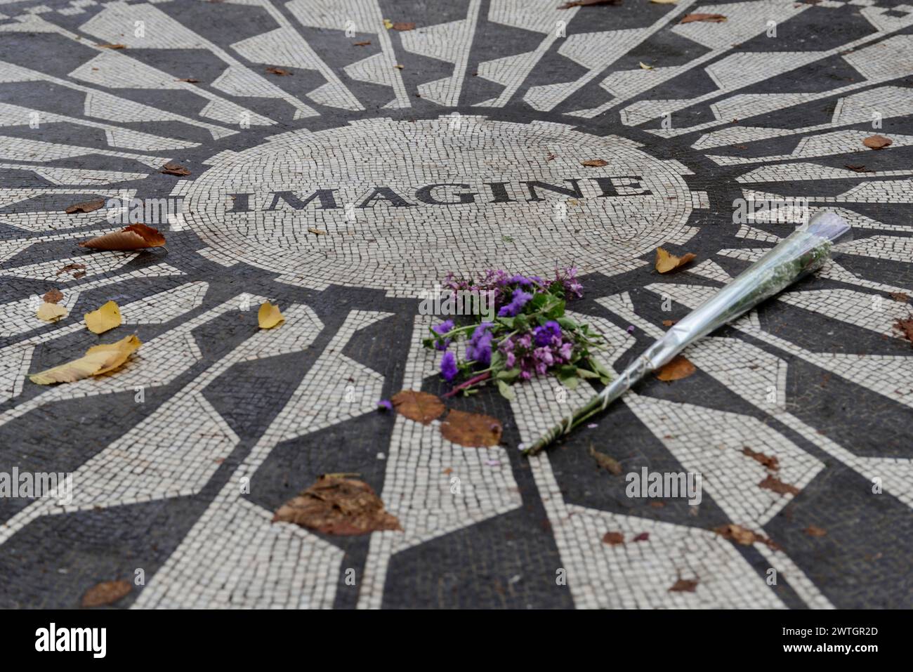 Central Park, street mosaic with the word Imagine surrounded by autumn leaves and flowers as a tribute, Manhattan, New York City, New York, USA Stock Photo