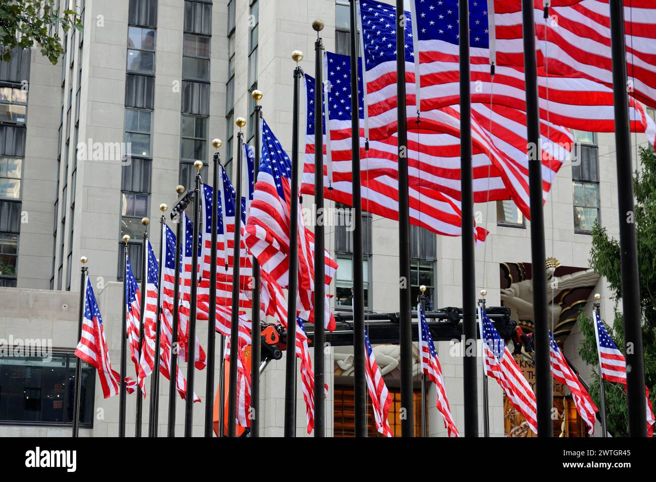 Rockfeller Center, Several American flags in front of a building, waving in the wind and showing patriotism, Manhattan, New York City, New York, USA Stock Photo