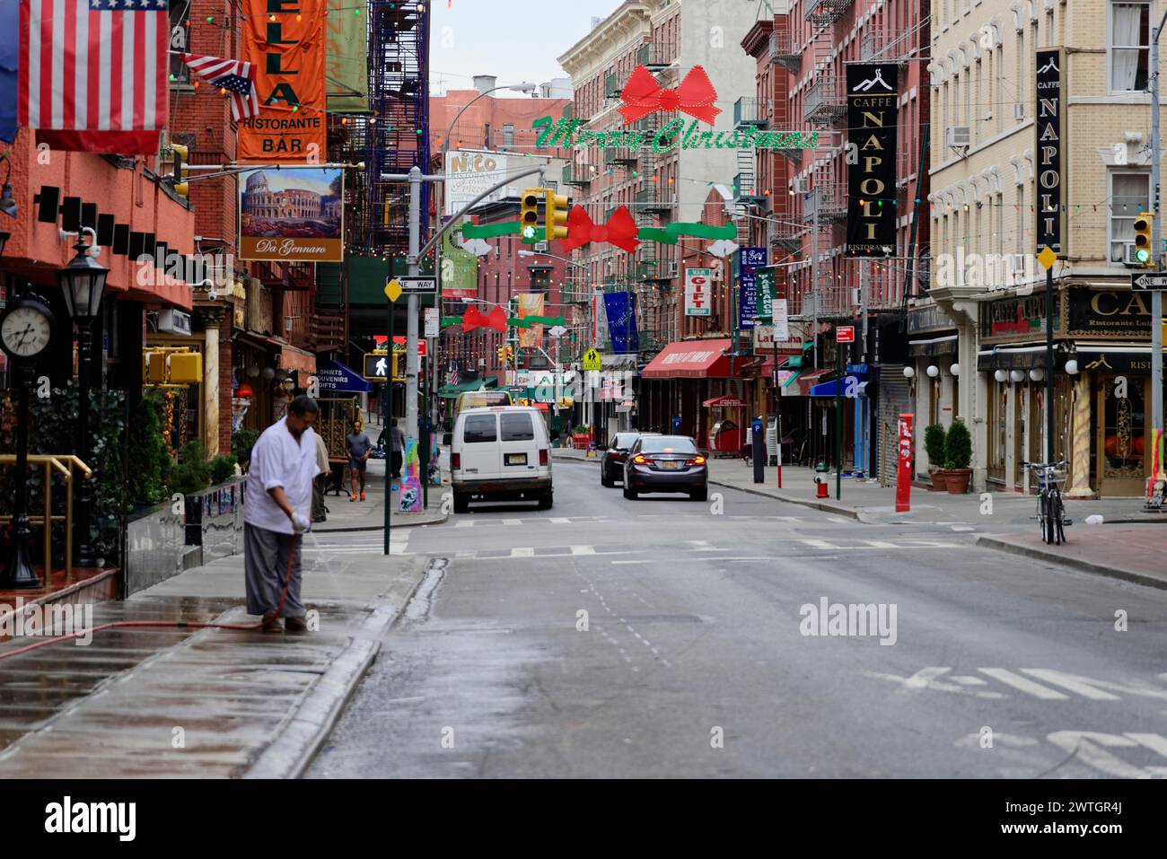 Busy street with shops and restaurants under colourful banners ...
