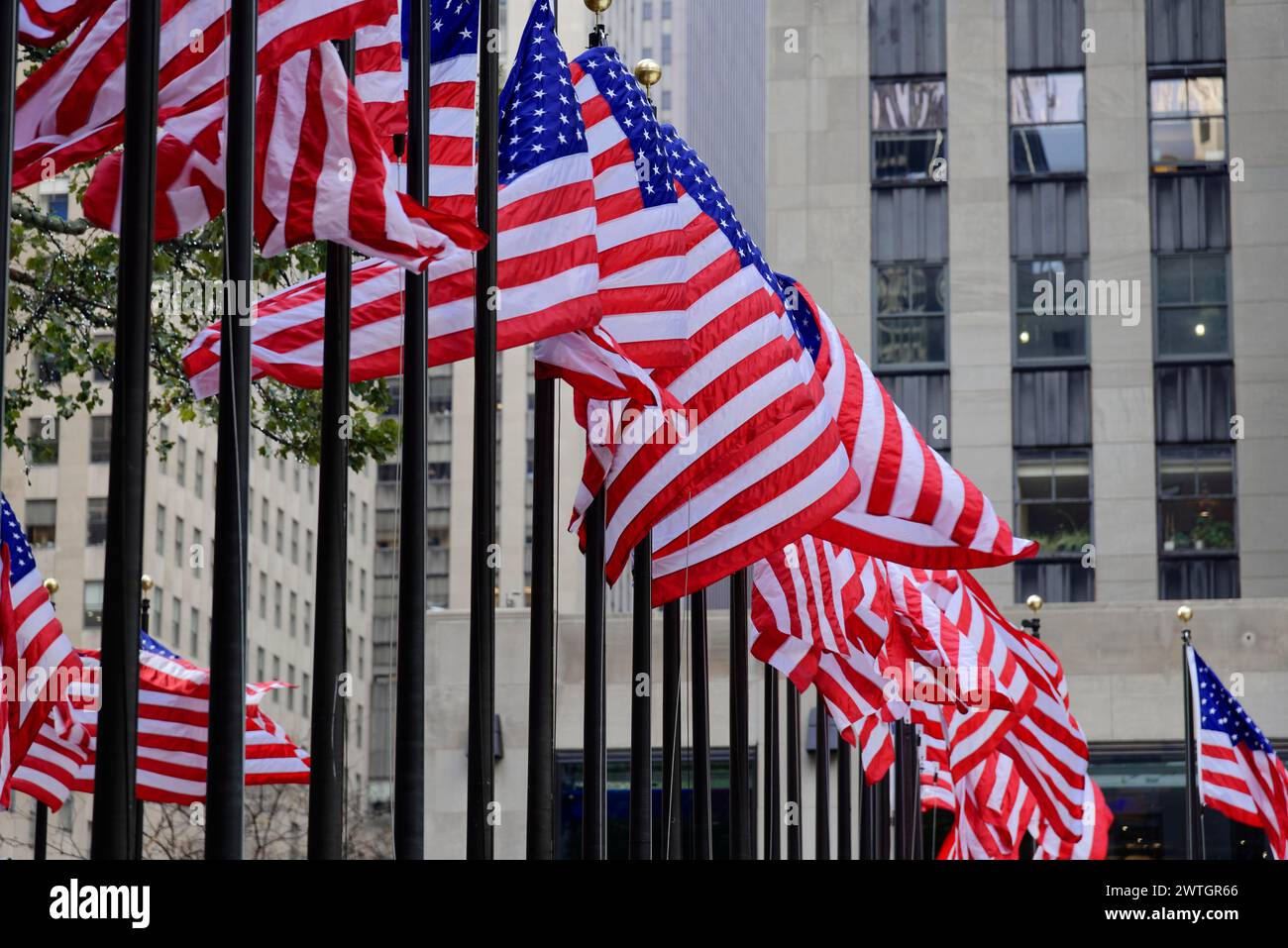 Rockfeller Center, Several US flags in a row in front of the entrance of a municipal building, Manhattan, New York City, New York, USA, North America Stock Photo