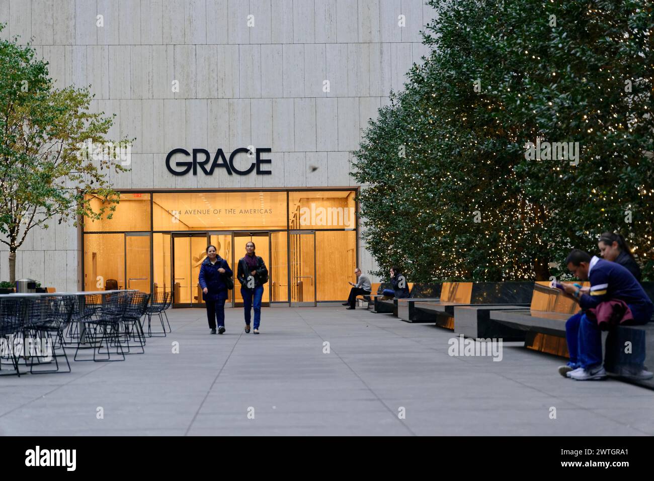 W. R. Grace Building, Manhattan, people walking by and sitting in an urban environment at twilight, New York City, New York, USA, North America Stock Photo