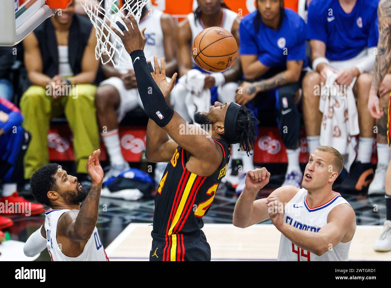 Los Angeles, United States. 17th Mar, 2024. Atlanta Hawks' Bruno Fernando (C) goes to the basket between Los Angeles Clippers' Paul George (L) and Daniel Theis (R) during an NBA basketball game at Crypto.com Arena on Sunday, March 17, 2024 in Los Angeles. Final Score: Hawks 110:93 Clippers (Photo by Ringo Chiu/SOPA Images/Sipa USA) Credit: Sipa USA/Alamy Live News Stock Photo